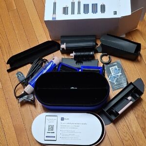 Dyson styling kit in blue and pink with travel case